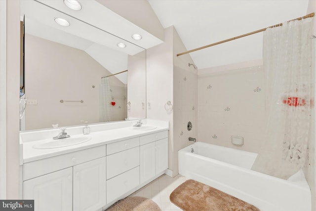 bathroom with tile flooring, vaulted ceiling, dual vanity, and shower / bath combination with curtain