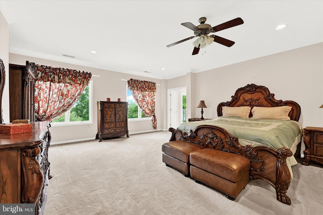 carpeted bedroom featuring ornamental molding and ceiling fan