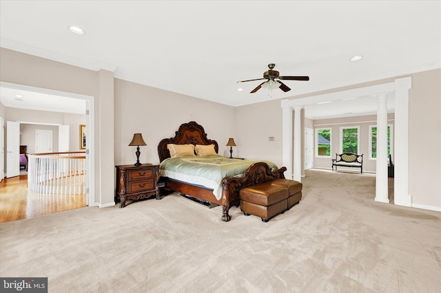 bedroom featuring carpet flooring, ceiling fan, crown molding, and ornate columns