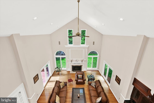 living room featuring high vaulted ceiling, hardwood / wood-style floors, and ceiling fan