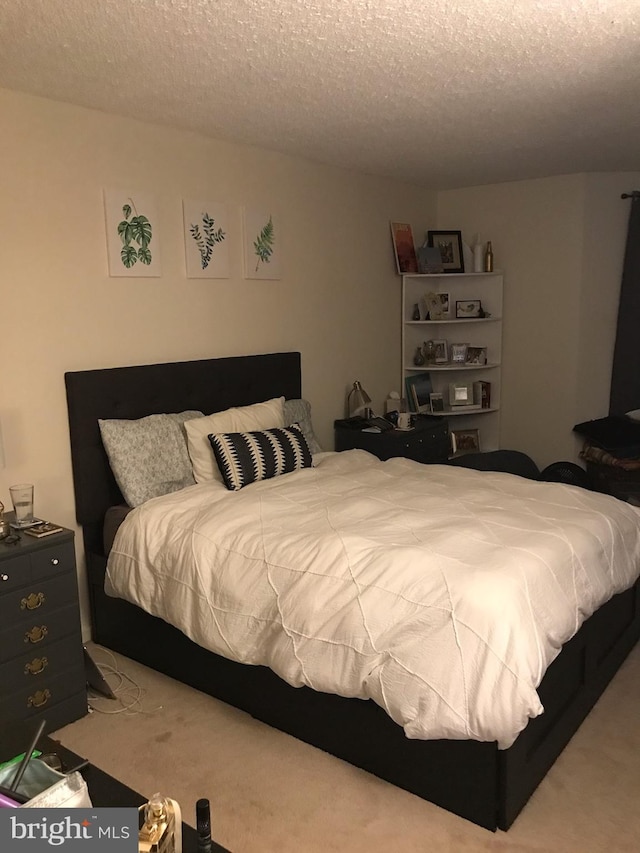 carpeted bedroom featuring a textured ceiling