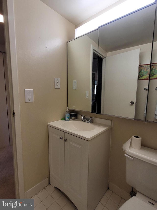 bathroom featuring vanity, toilet, and tile floors