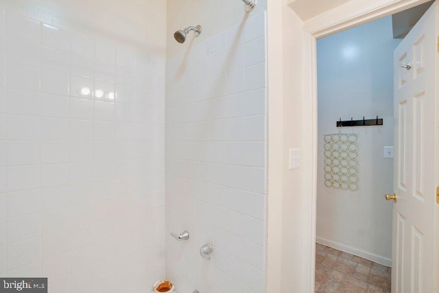 bathroom with tile floors and tiled shower / bath