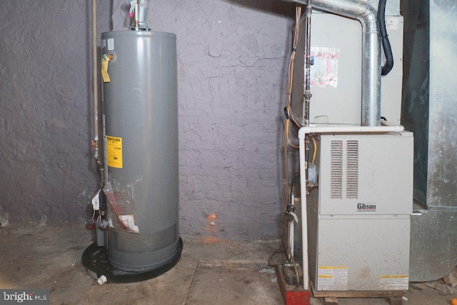 utility room featuring water heater and heating utilities