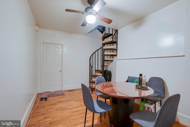 dining area with light hardwood / wood-style floors and ceiling fan