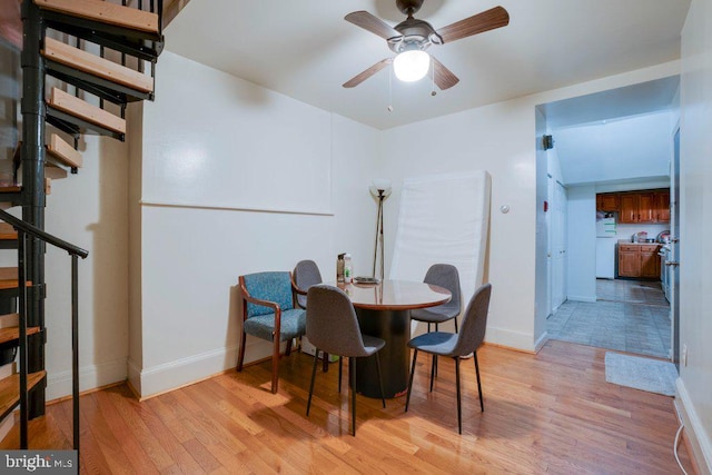 tiled dining space featuring ceiling fan