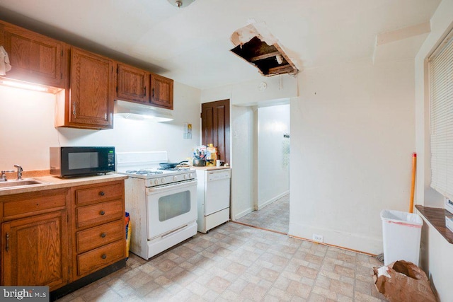 kitchen with white appliances, sink, and light tile flooring