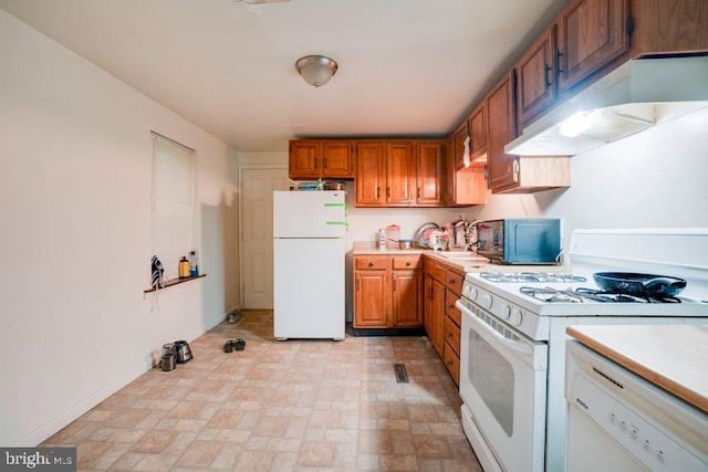 kitchen with white appliances and light tile floors