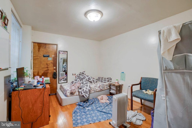 living room with wood-type flooring and radiator heating unit