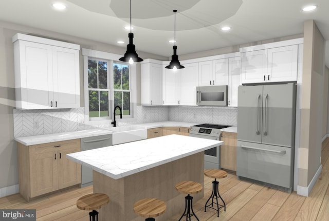 kitchen with appliances with stainless steel finishes, a kitchen island, backsplash, and white cabinetry