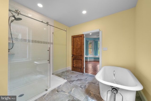 bathroom with shower with separate bathtub