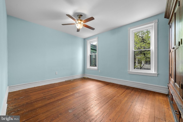 empty room with hardwood / wood-style floors and ceiling fan