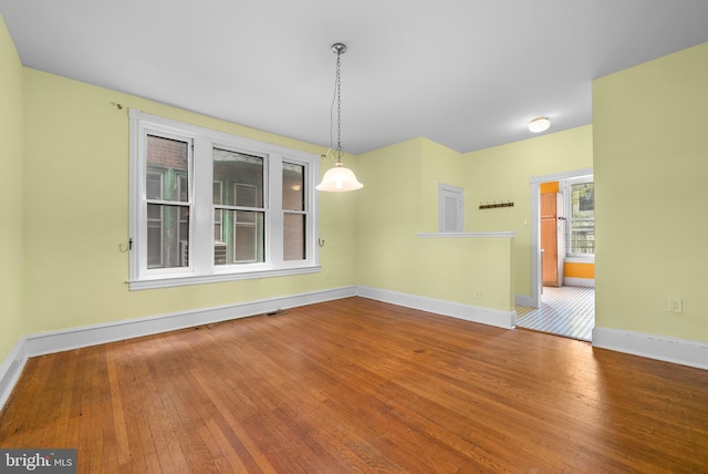 unfurnished dining area featuring hardwood / wood-style floors