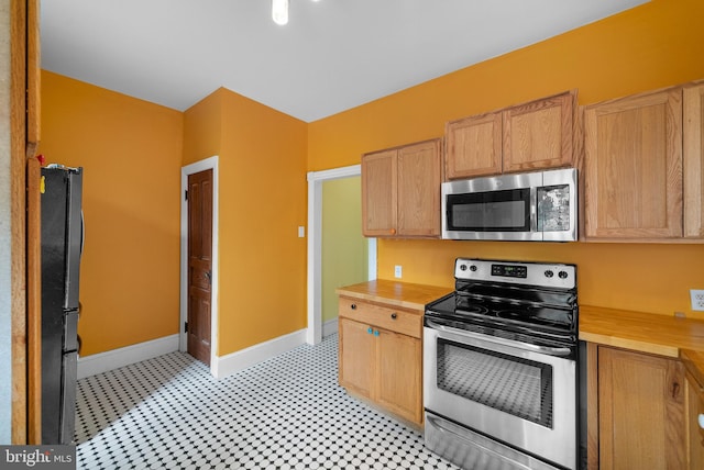 kitchen featuring light brown cabinetry and stainless steel appliances