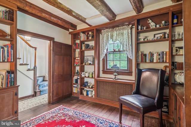 sitting room with hardwood / wood-style floors, beamed ceiling, and radiator