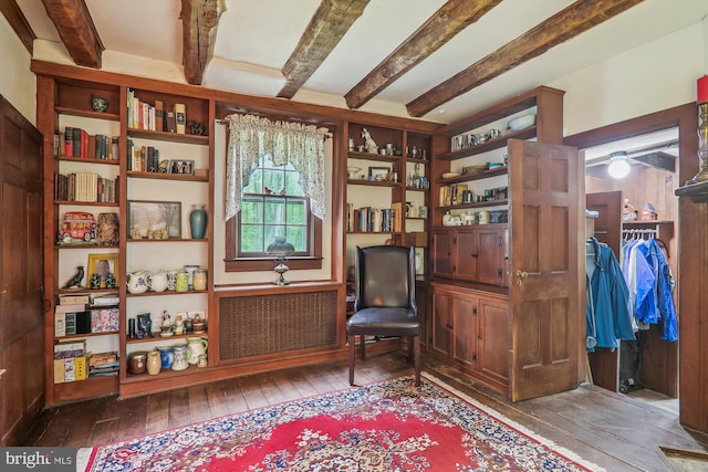 sitting room with wood-type flooring, beam ceiling, and radiator heating unit