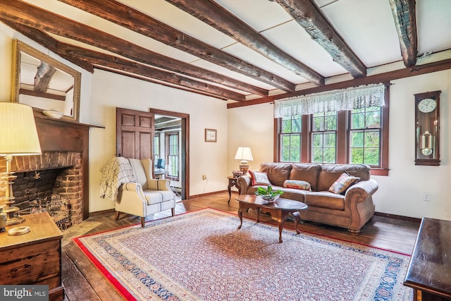 living room featuring beamed ceiling, hardwood / wood-style floors, and a fireplace