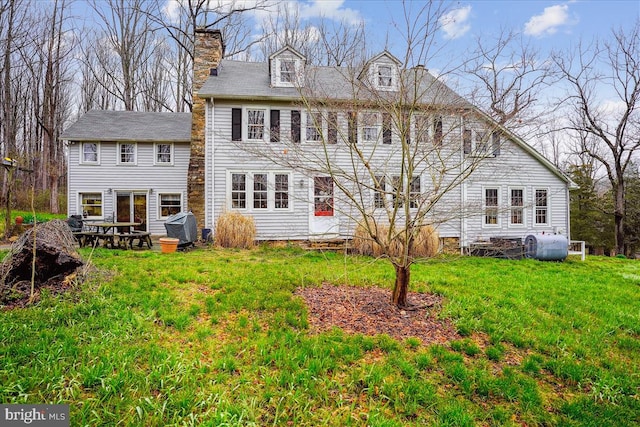 rear view of property with a yard