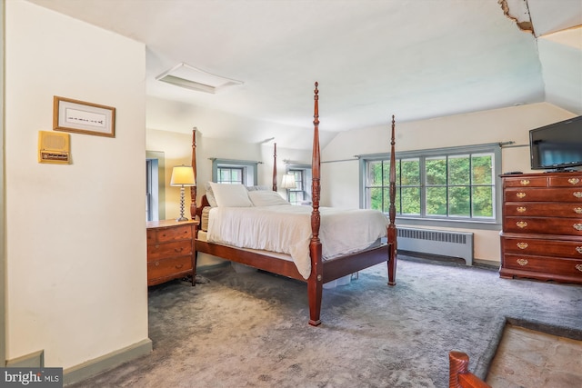 carpeted bedroom with vaulted ceiling and radiator heating unit