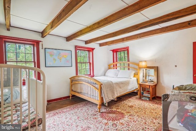 bedroom featuring beam ceiling and tile floors