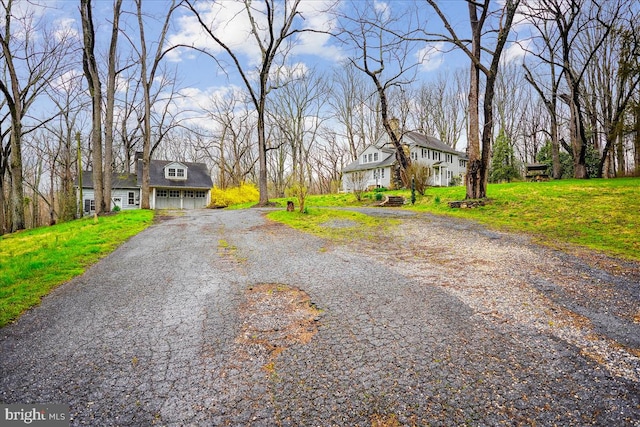 view of front of home with a garage and a front lawn