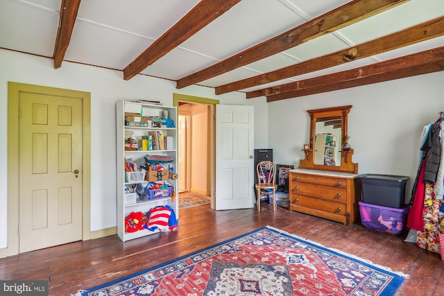 living area featuring hardwood / wood-style floors and beamed ceiling