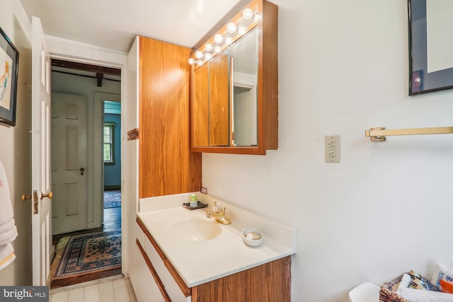 bathroom with tile flooring and vanity