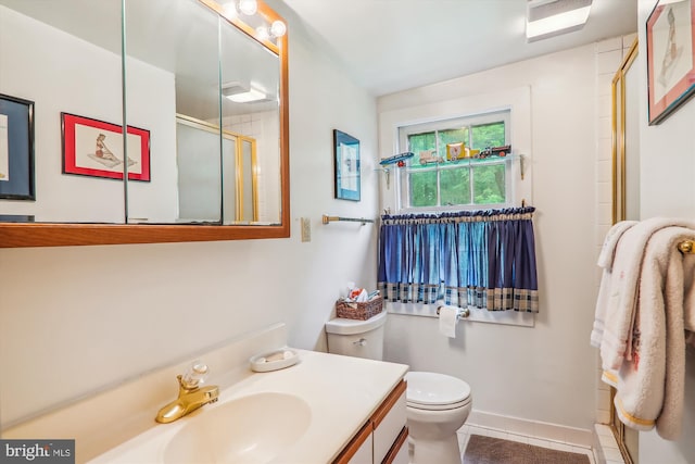 bathroom with vanity, tile floors, and toilet