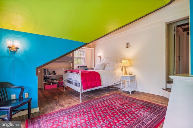 bedroom with dark hardwood / wood-style flooring