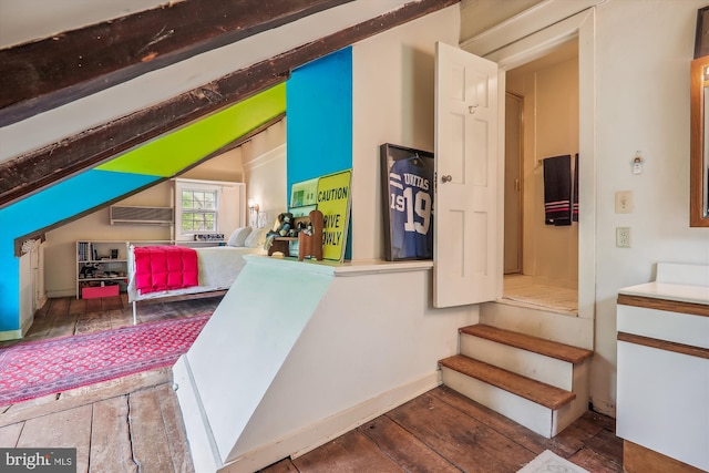 stairs with vaulted ceiling and dark hardwood / wood-style flooring