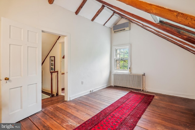 interior space featuring a wall unit AC, radiator, hardwood / wood-style floors, and vaulted ceiling with beams