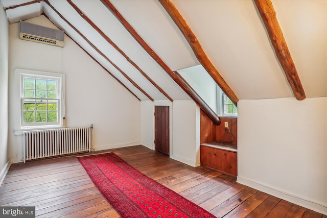 additional living space featuring a wall mounted air conditioner, hardwood / wood-style floors, vaulted ceiling with beams, and radiator heating unit