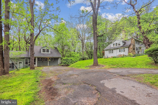 view of front of property with a garage and a front lawn