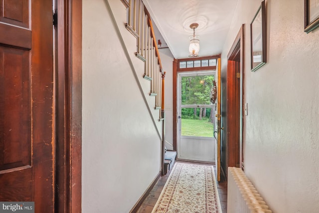 doorway with radiator heating unit and tile floors