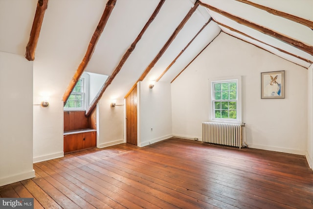 bonus room featuring hardwood / wood-style floors, beamed ceiling, radiator heating unit, and high vaulted ceiling