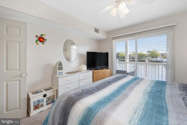 carpeted bedroom featuring visible vents and a ceiling fan