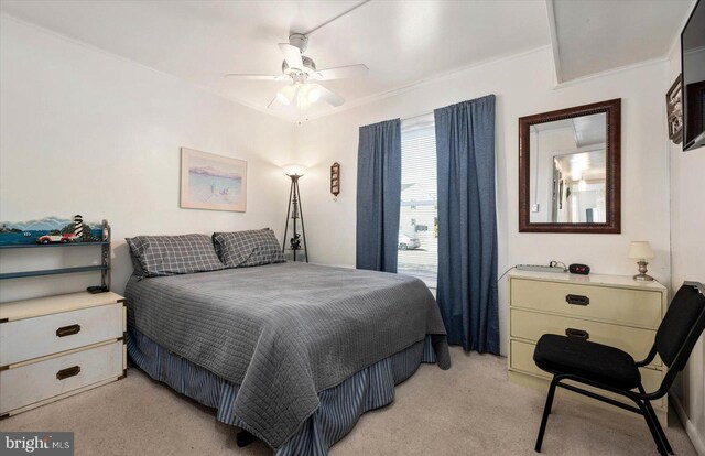 bedroom with light carpet and a ceiling fan