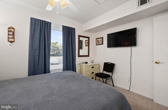 bedroom featuring visible vents, carpet flooring, baseboards, and ornamental molding