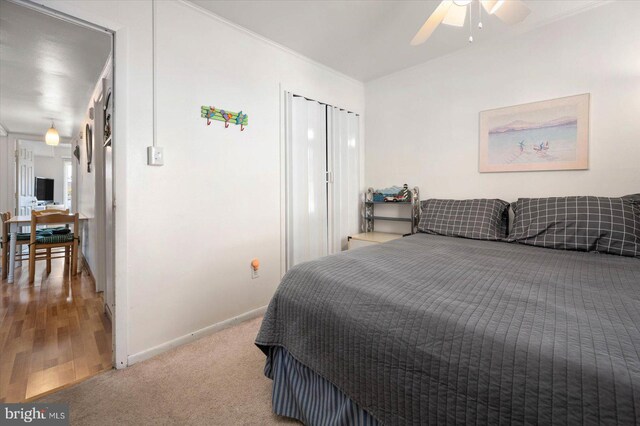 carpeted bedroom featuring a ceiling fan and baseboards