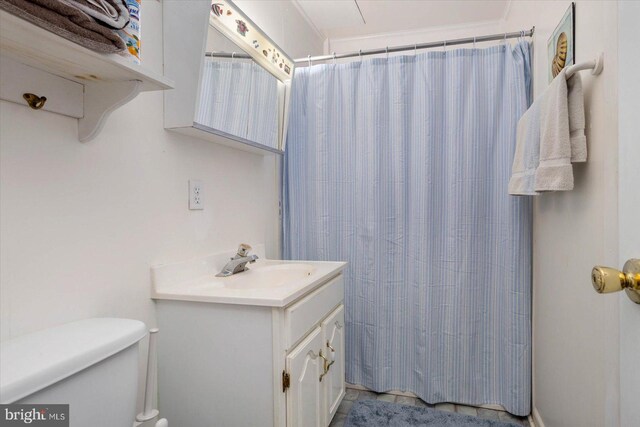 bathroom featuring curtained shower, toilet, and vanity