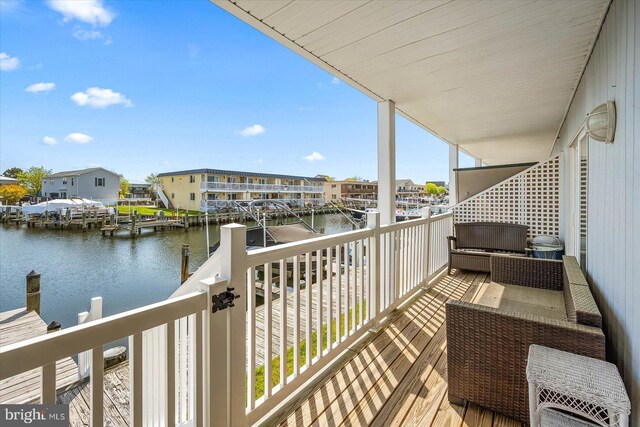 balcony featuring a water view and a residential view