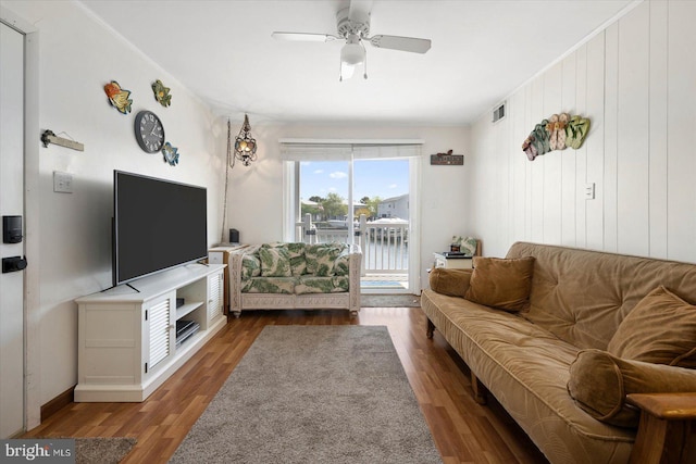 living area featuring wood finished floors, visible vents, and ceiling fan