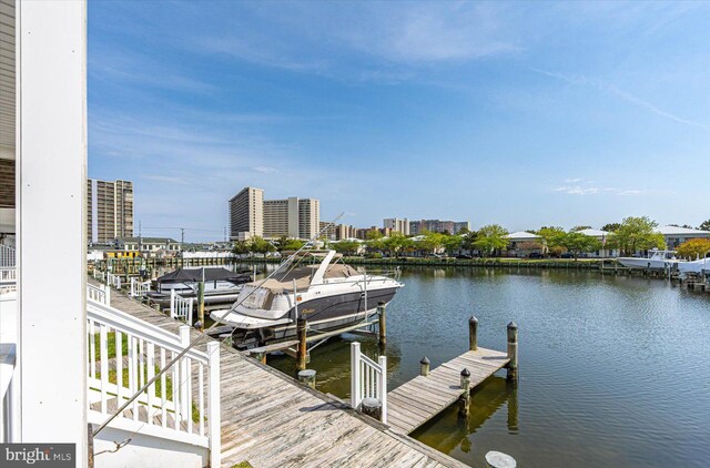 view of dock with a view of city and a water view