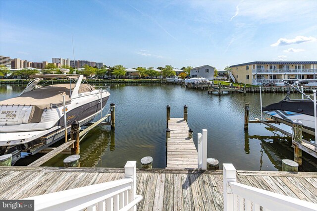 view of dock with boat lift and a water view