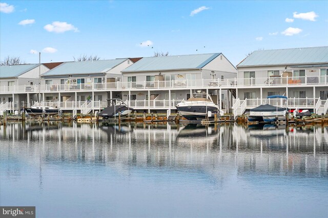 view of water feature featuring a dock and a residential view