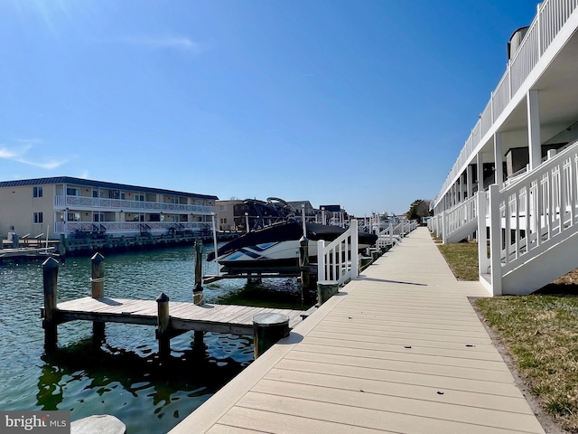 view of dock featuring boat lift and a water view