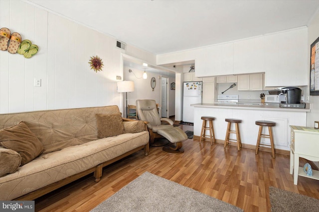 living room featuring visible vents and light wood-style flooring