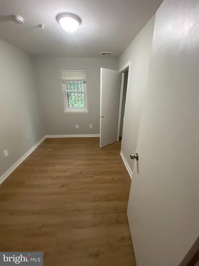 unfurnished room featuring hardwood / wood-style flooring