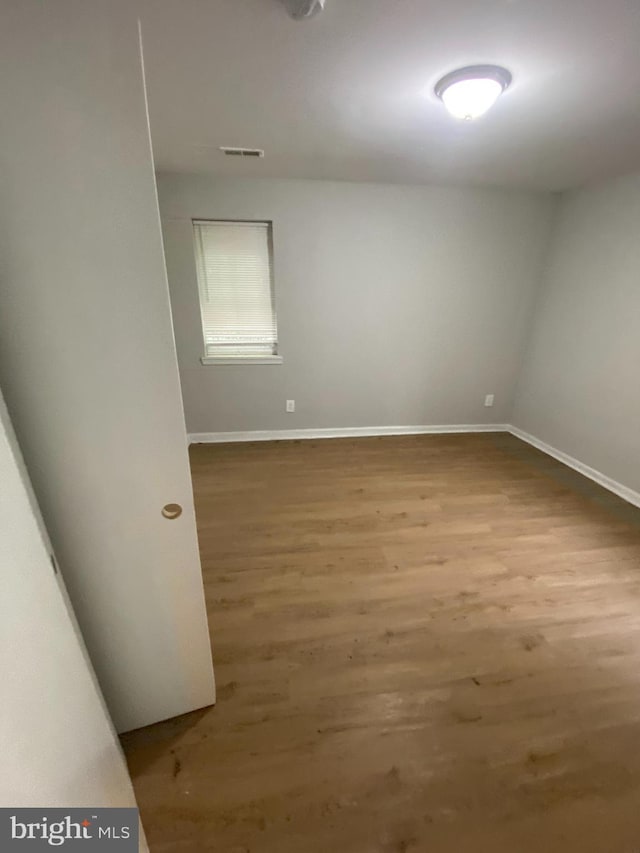 spare room with wood-type flooring