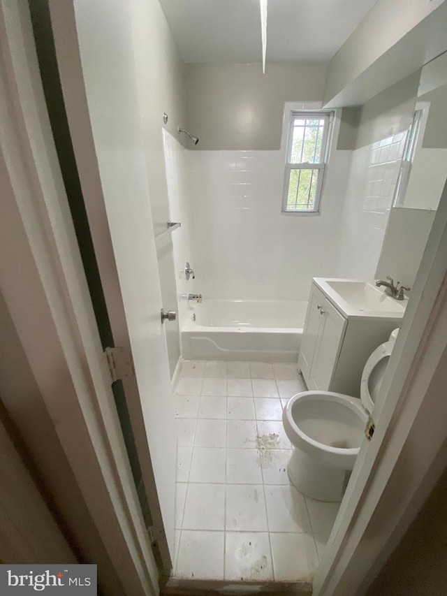 full bathroom with washer / dryer, toilet, tile flooring, vanity, and shower / washtub combination